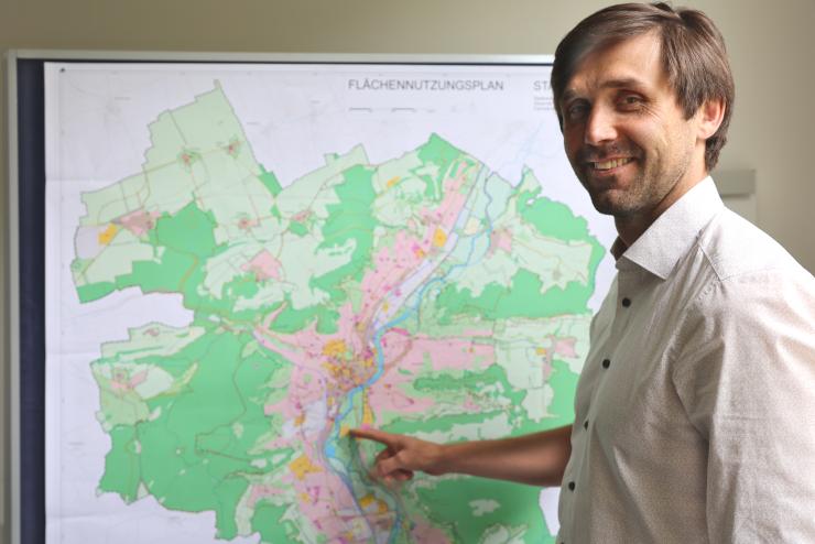 Dezernent Dirk Lange zeigt auf den neuen Flächennutzungsplan der Stadt Jena