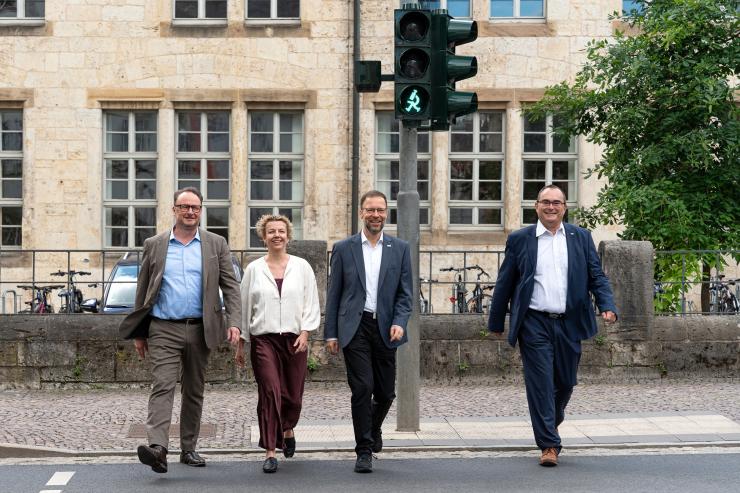 Vier Personen an einem Fußgängerüberweg 