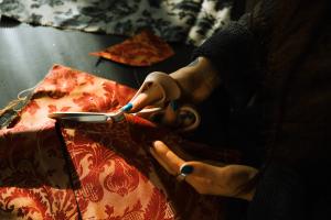 Person schneidet Stoff zu