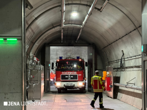 Ein Feuerwehrauto durchfährt einen Querschlag im Tunnel, der die südliche mit der nördlichen Tunnelröhre verbindet.