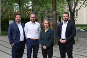 vier menschen schauen in die Kamera.