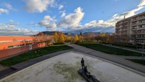 Blick auf einen Brunnen mit umliegenden Gebäuden.