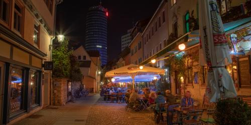 Eine Gasse in der Nacht mit Außengastronomie
