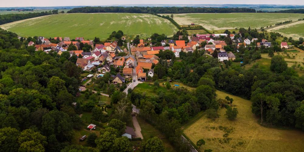 Ein ländlicher Ortsteil mit Wald und Feld