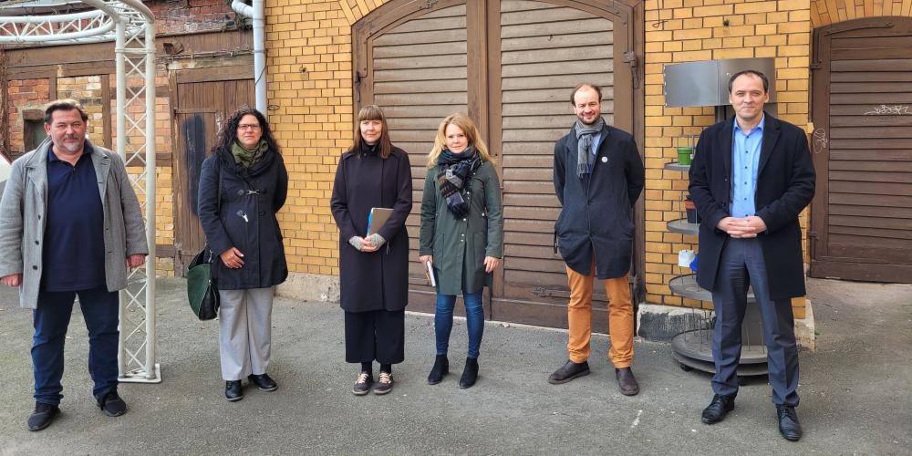 Sechs Menschen vor einem Tor