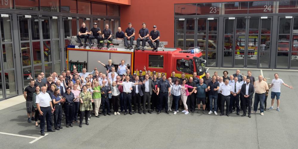 Viele Menschen vor einem Feuerwehr-Auto