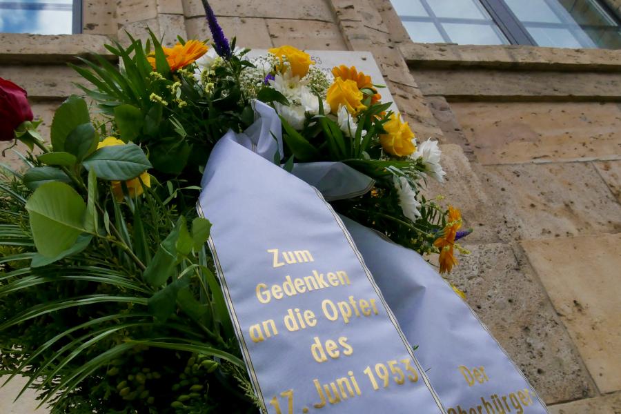 Ein Blumengebinde mit einer Schleife, drauf die Aufschrift: Den Opfern des 17. Juni 1953