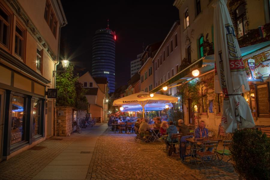 Eine Gasse in der Nacht mit Außengastronomie