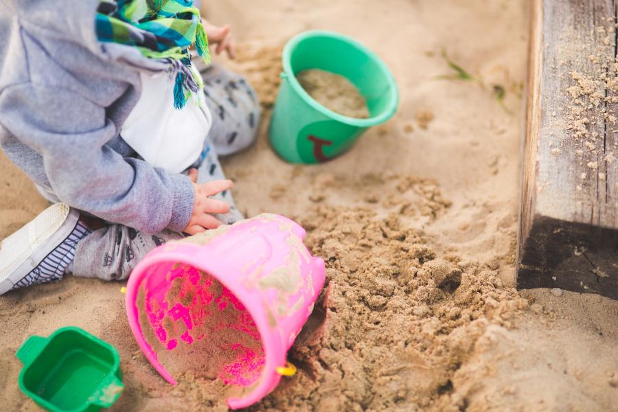 Ein Kind spielt im Sandkasten