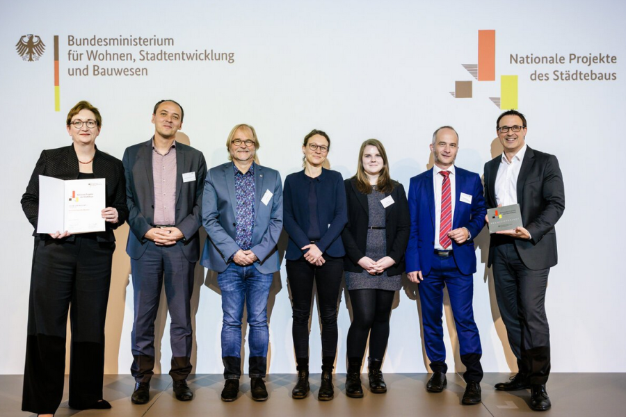 Sieben Menschen lächeln in die Kamera