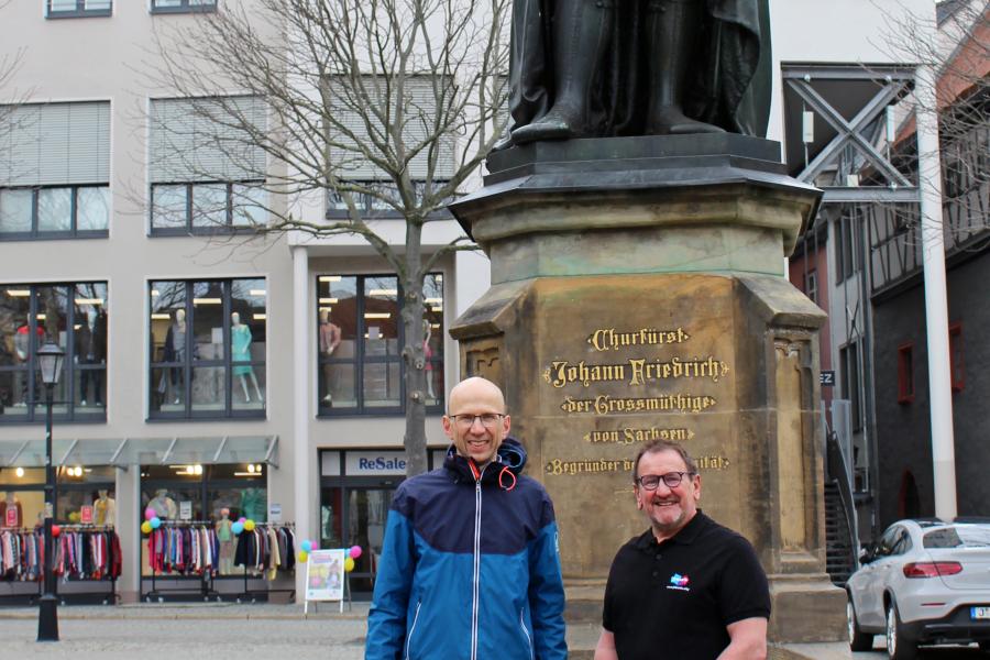 Wilfried Röpke und Peter Böttger stehen auf dem Jenaer Marktplatz vor dem Hanfried.